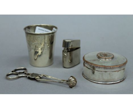 A 900 silver beaker, a pair of sugar tongs, a coin set plated box and a travelling inkwell. The former 6.5 cm high and 45.7 g