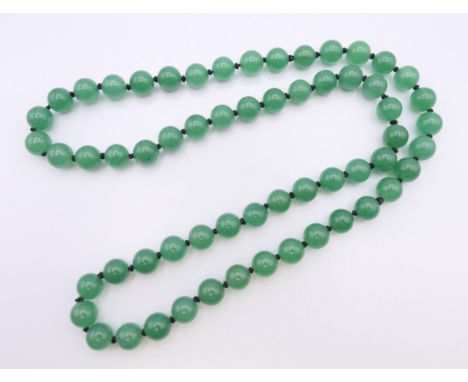 A string of jade beads.  68 cm long.
