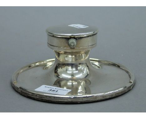A large silver Capstan inkwell with inset gentleman's pocket watch to the lid, with clear glass liner. 15 cm diameter. 