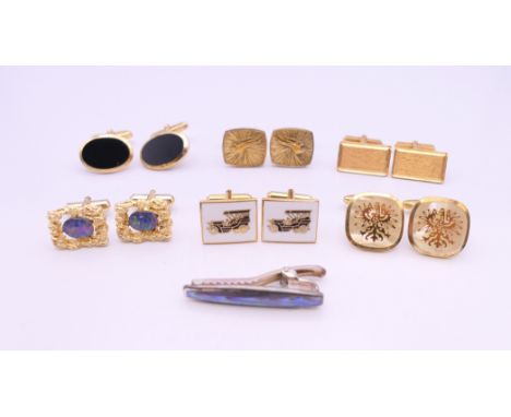 Six pairs of cufflinks and a tie clip.  Car motif cufflinks 2 x 1.5 cm.