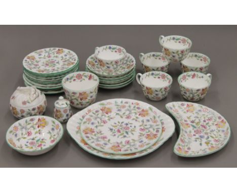 A quantity of vintage Minton Haddon Hall bone china tea wares, including cups and saucers, side plates, cake plates and a jam
