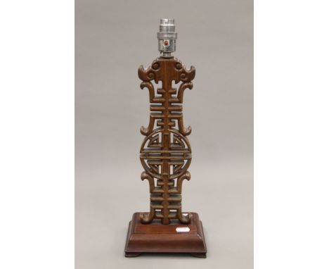 A vintage Chinese wooden table lamp. 43 cm high.