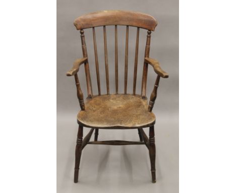 A Victorian elm seated stick back open armchair. 53 cm wide.