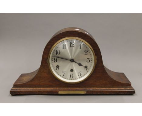 A large Napoleons hat shaped clock with full Westminster chimes movement and brass dedication plaque inscribed 'From the Mana