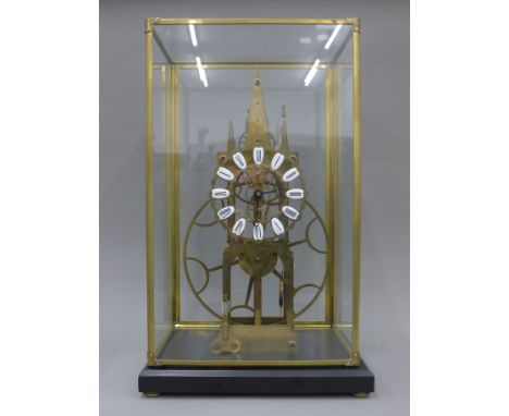A brass skeleton clock in a glass case. 54 cm high overall.