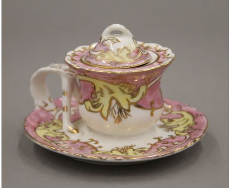 A 19th century porcelain inkwell. 7 cm high.