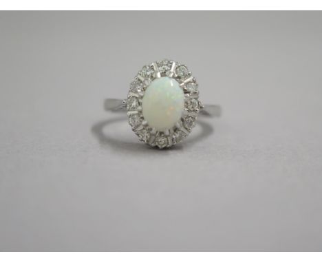 An 18ct white gold opal and diamond ring - head size approx 13mm x 11mm - ring size approx M 