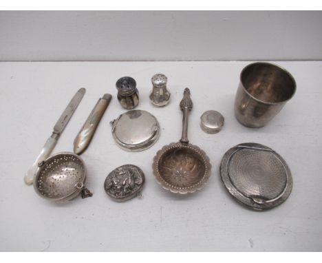 Assorted silver items - two powder compact, pepper shakers, cup, tea strainers, fruit knife, locket and box 