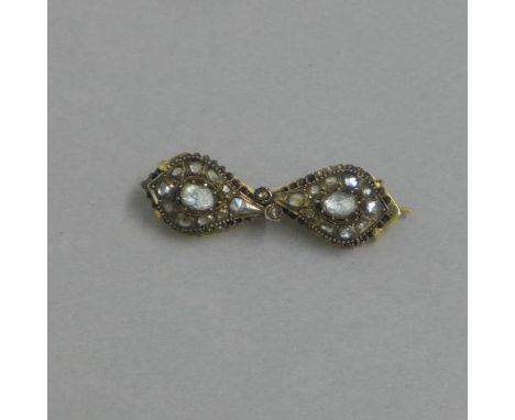 A pair of antique diamond drop earrings (possibly Mughal) set as a brooch - each drop set with central rose cut diamond (appr