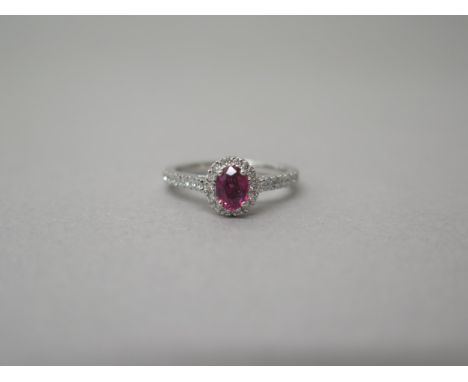 A platinum ruby and diamond ring - diamonds well matched, bright and lively - head size approx 8mm x 7mm with diamond shoulde