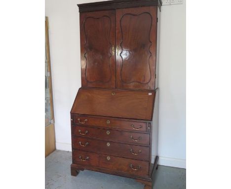 A good quality early 19th century flame mahogany bureau bookcase with two doors above the base which has a fitted interior, n