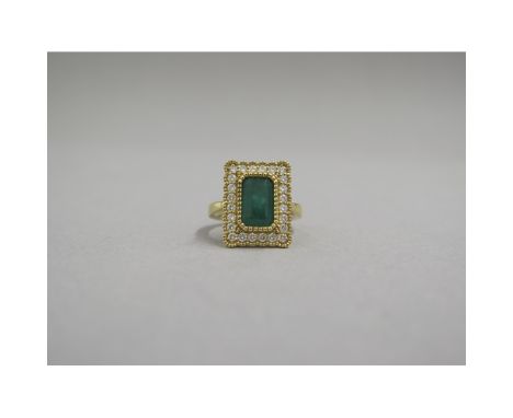 A very good 18ct yellow gold (hallmarked) emerald and diamond ring - the rectangular step cut emerald approx 2.28ct surrounde