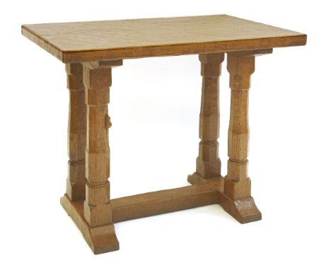 A Robert 'Mouseman' Thompson oak side table or extension,  the rectangular adzed top raised on four octagonal supports and on