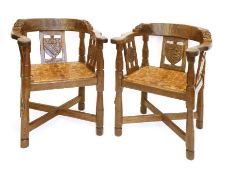 A pair of Robert ‘Mouseman’ Thompson monk’s armchairs, each back rail with a carved boss and mask, the central splat with a s