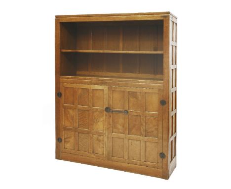 A Robert 'Mouseman' Thompson oak bookcase, the open book shelf with a single adjustable shelf, over a latticed cupboard, with