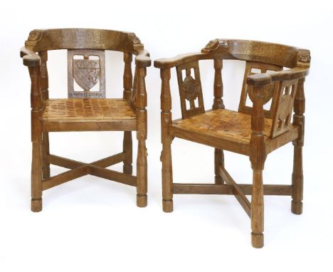 A pair of Robert 'Mouseman' Thompson monk’s armchairs, each back rail with a carved boss and mask, the central splat with a s