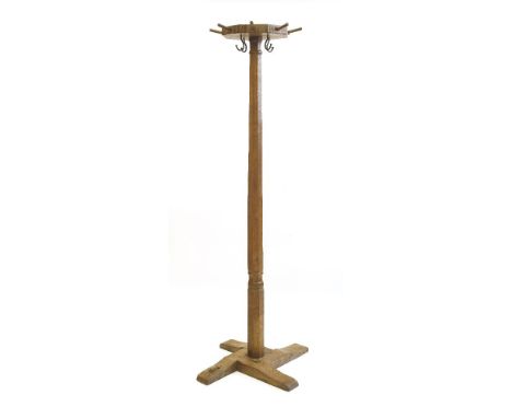 A Robert 'Mouseman' Thompson oak coat stand, the octagonal top with eight pegs and four hooks, on a flat four-platform base, 