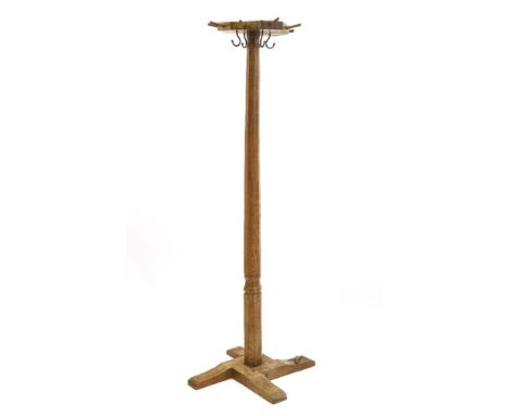 A Robert 'Mouseman' Thompson coat stand,the octagonal top with eight pegs and four hooks, on a flat four-platform base, with 