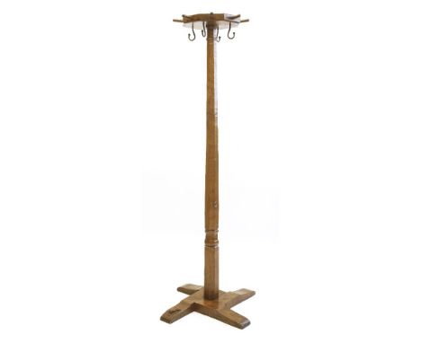 A Robert 'Mouseman' Thompson oak coat stand, the octagonal top with eight pegs and four iron hooks, on a flat four-platform b