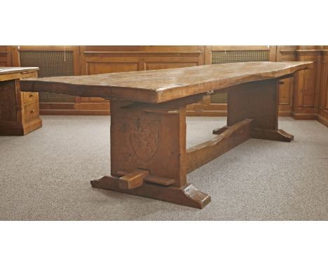 A Robert 'Mouseman' Thompson oak refectory table, the adzed two-plank top over solid end supports, each carved with a shield 