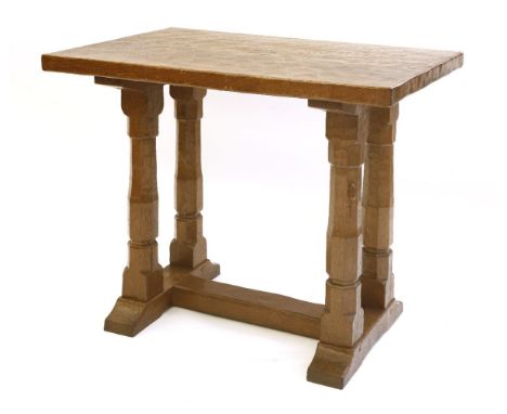 A Robert 'Mouseman' Thompson oak side table or extension, the rectangular adzed top raised on four octagonal columns on an ‘H