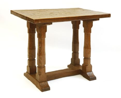 A Robert 'Mouseman' Thompson oak side table or extension, the rectangular adzed top raised on four octagonal columns on an ‘H