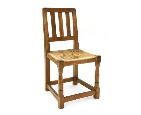 A Robert ‘Mouseman’ Thompson oak chair, with vertical splats and leather seats united with plain stretchers, with a mouse sig