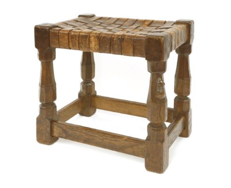 A Robert 'Mouseman' Thompson oak stool,with a lattice leather seat, octagonal supports, united with plain stretchers, with mo