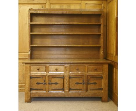 A Robert 'Mouseman' Thompson oak dresser,  with three shelves, over an adzed top with scrolled corners over four drawers and 