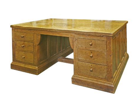 A Robert ‘Mouseman’ Thompson oak partners' desk, with an adzed top and scrolled corners with three drawers either side of the