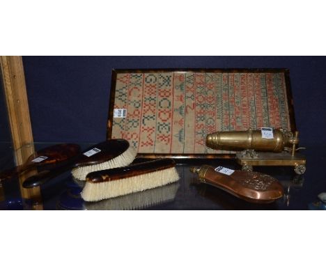 A mixed lot, to include a sampler, copper powder flask, brass canon and faux tortoiseshell brush set (6) CONDITION REPORT: Lo