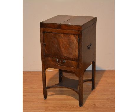 A 19th century mahogany commode, with hinged divided top above panelled door, drawer and undertier, metal carry handles to ea