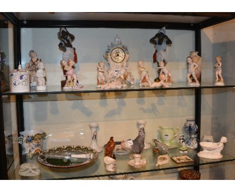 A mixed lot of porcelain, to include Continental putti style figures, mantel clock, Blackamoor style figures, Royal Copenhage