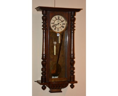 A mahogany cased Vienna wall clock by Gustav Becker, the glazed door enclosing cream enamel dial with subsidiary seconds dial