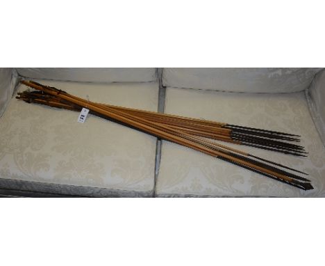 A quantity of Peruvian spears/arrows with bow, the arrows with bamboo body, carved painted wooden tip and feather ends (13)