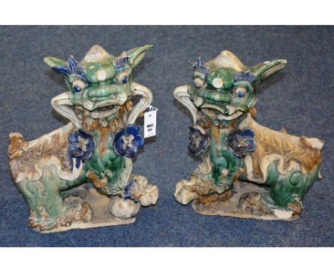 A pair of Chinese ceramic dog of foe figures, glazed in green, brown and blue, 49cm high x 38cm wide (a/f) (2)