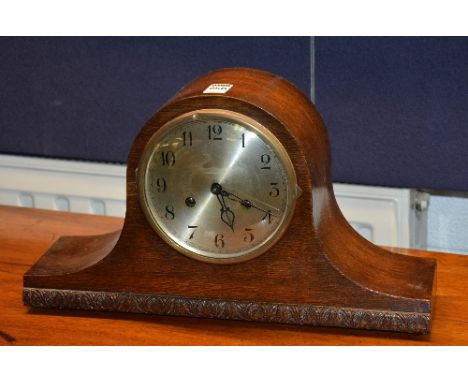 An oak cased mantel clock, the silvered dial with Arabic numerals, 24cm high x 42cm wide x 13cm deep