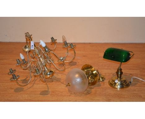 A collection of brass lights and lamps, to include a 12 branch chandelier, hall light with frosted glass bowl, green glass de