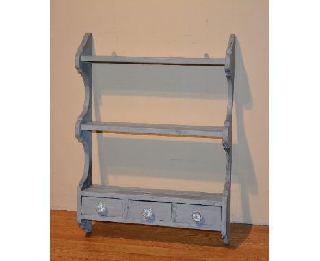 A painted pine hanging wall shelf, with open shelves above three small drawers, 83cm high x 62cm wide