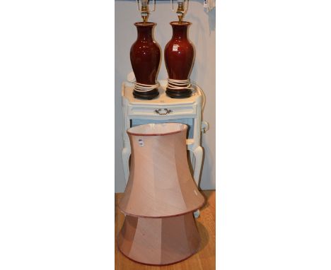 A pair of Chinese style sang de boef ceramic vase lamps with shades, raised on fixed hardwood stands, 36cm high