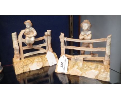 Two Royal Worcester ornaments in the form of children leaning against gates