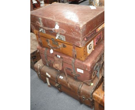 A canvas wooden bound travelling trunk and three further pieces of vintage luggage
