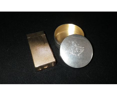 A circular silver pill box with engraved monogram and a Myon gold plated engine-turned lighter (2)