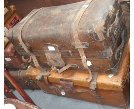 A large leather travelling trunk with straps and red fitted interior, together with another similar