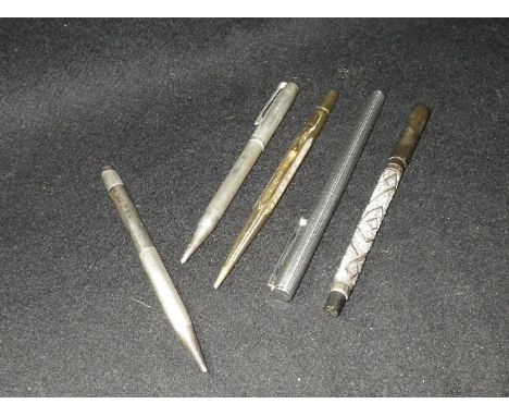 Two engine-turned silver cased pencils, a repousse silver mounted Swan fountain pen and two others (5)