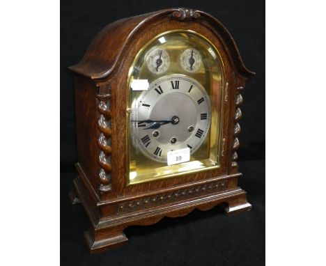 A 1920's oak-cased mantel clock by Gustav Becker with brass and silvered dial and Westminster chime