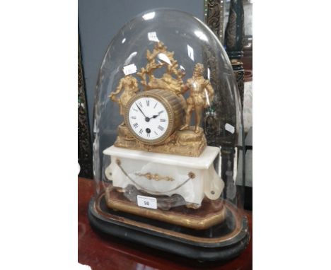 A Victorian gilt spelter and alabaster clock under a glass dome with French movement and enamel dial