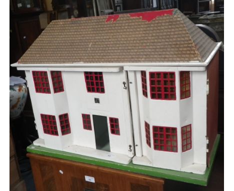 A vintage doll's house with stamped metal facade