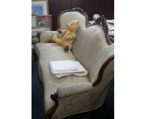 A Victorian walnut framed three seater sofa with carved cresting rail, upholstered in gold material