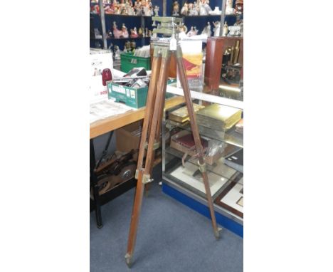 A Surveyor's tripod stand with extending wooden legs